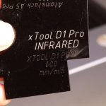 Engraving black acrylic with xTool1064nm infrared laser module compared to engraving made with 20W blue laser module